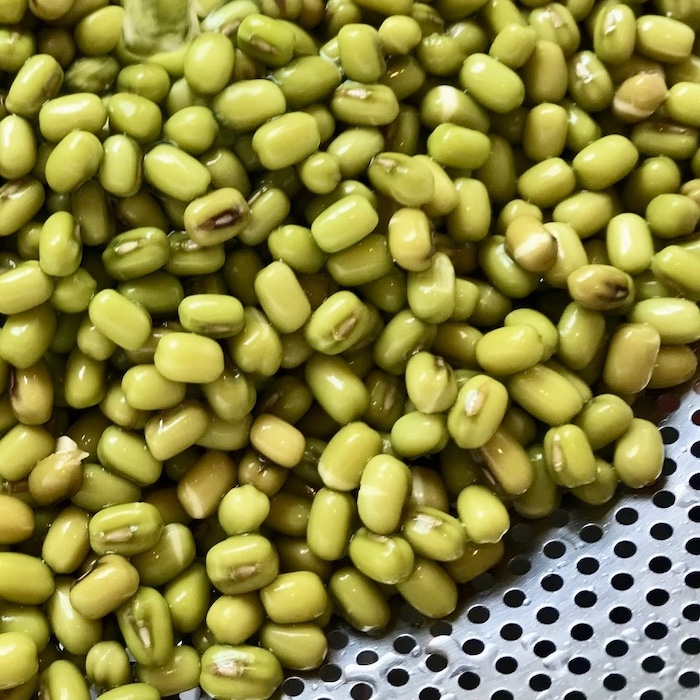 This is a photo of mung beans in a sieve.